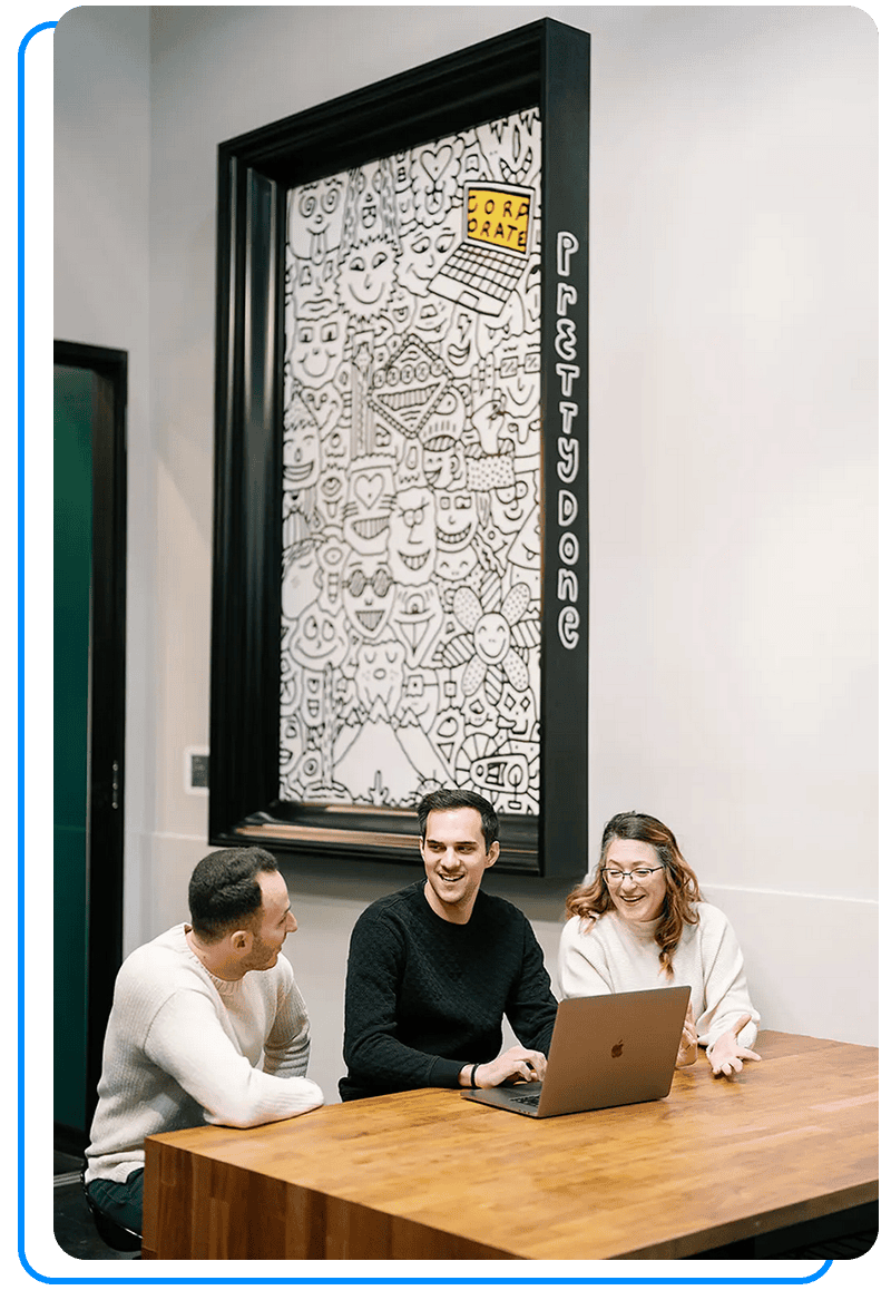 Adam speaking with clients at a table